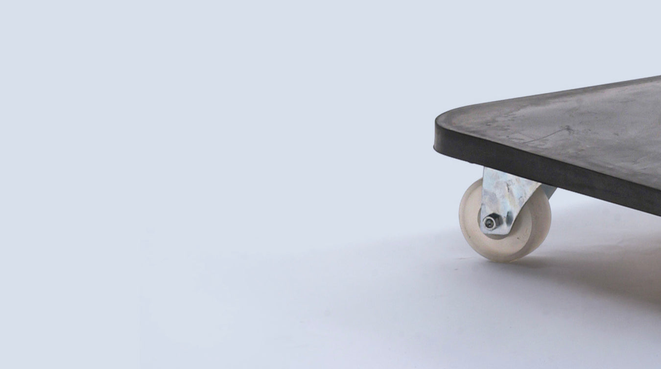 Close-up of trolley corner with visible wheel, showcasing Bluetrolley's bespoke design against a minimalist white background.